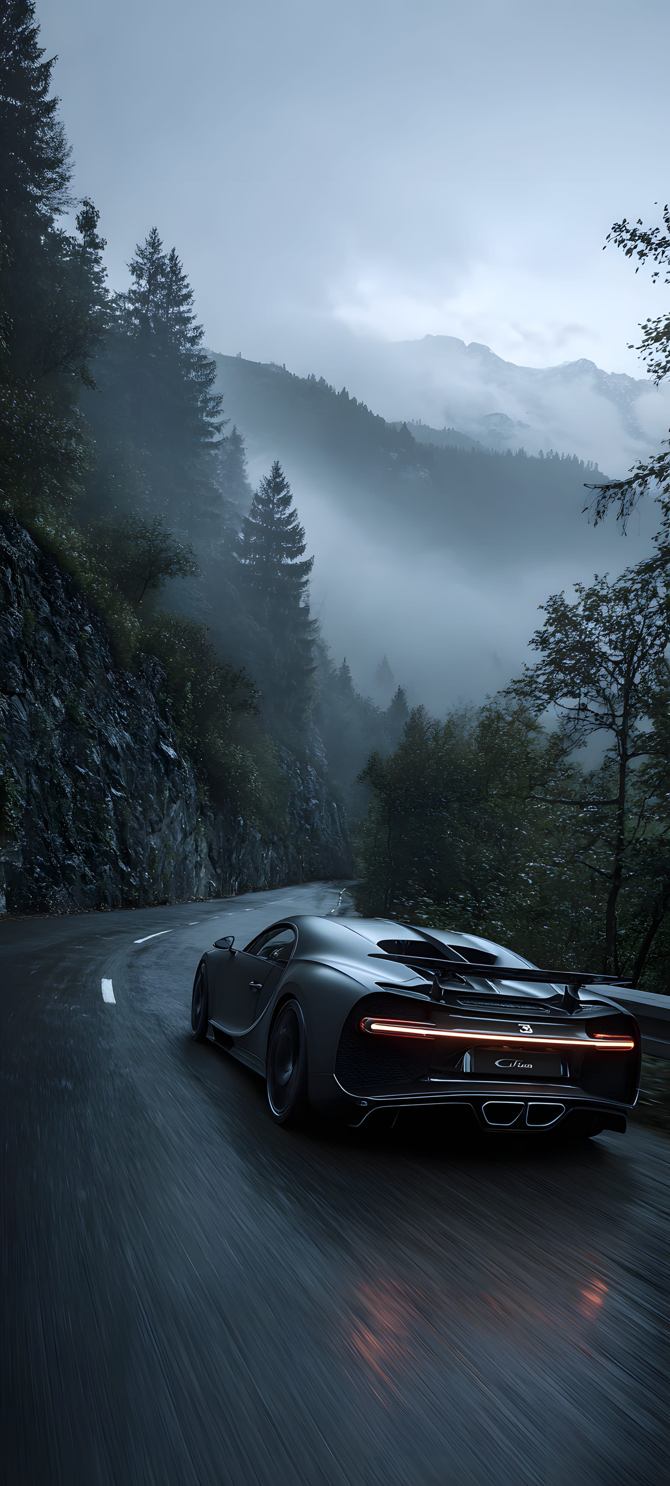 A black sports car driving on a rainy mountain road surrounded by dense forest and misty mountains.