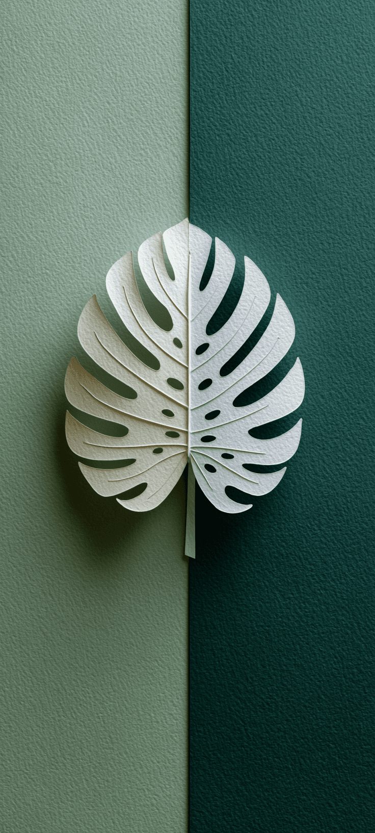 Minimalist leaf design wallpaper with a white leaf on a dual-toned green background.