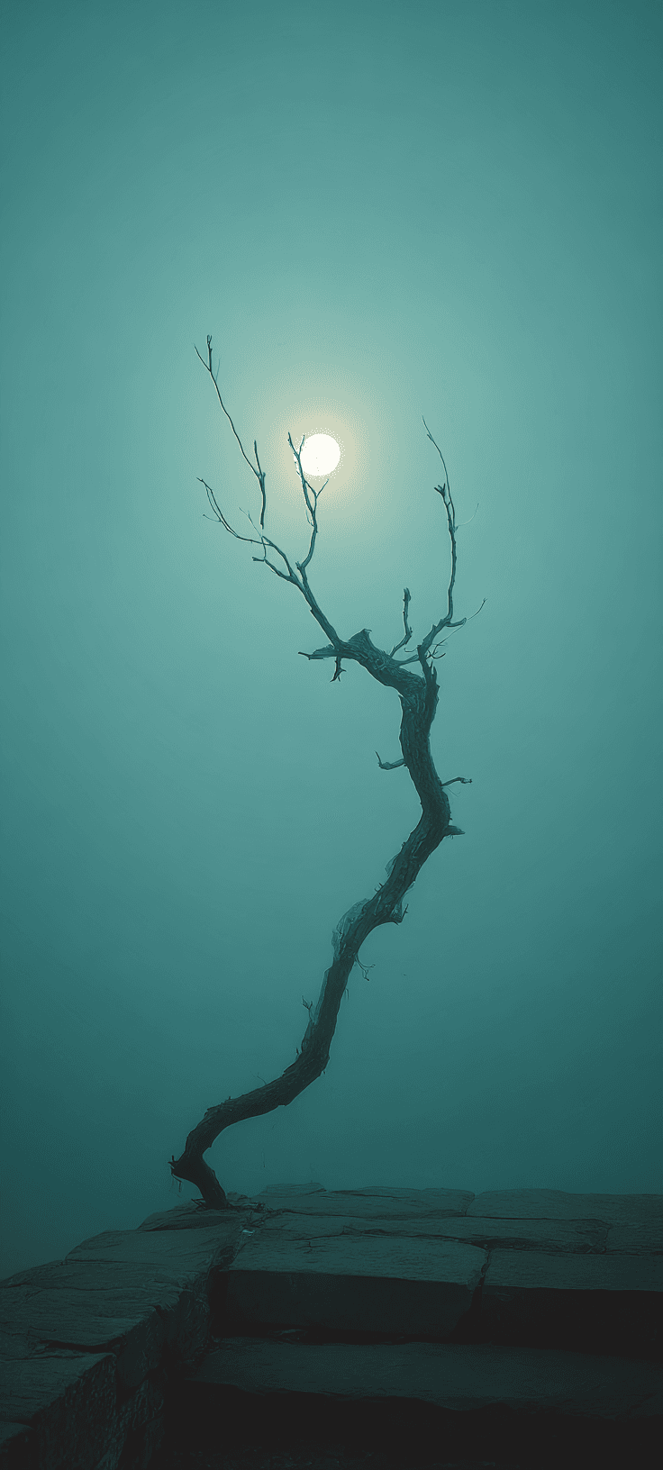 A vertical minimalist shot of a single leafless, twisted tree silhouette standing on a stone ledge against a thick teal fog with a bright full moon glowing through the haze.