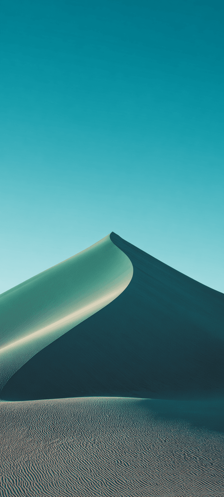 Surreal sand dune landscape with a vibrant blue sky and soft, undulating curves.